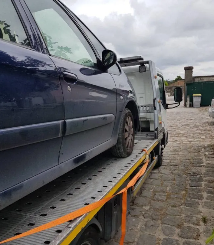 Voiture bleue sanglée sur un plateau à Chennevières-lès-Louvres