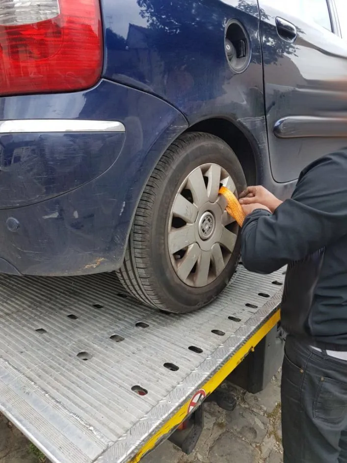 Dépanneur sanglant la roue d’une voiture bleue sur un plateau au Bourget – au Bourget (93350)