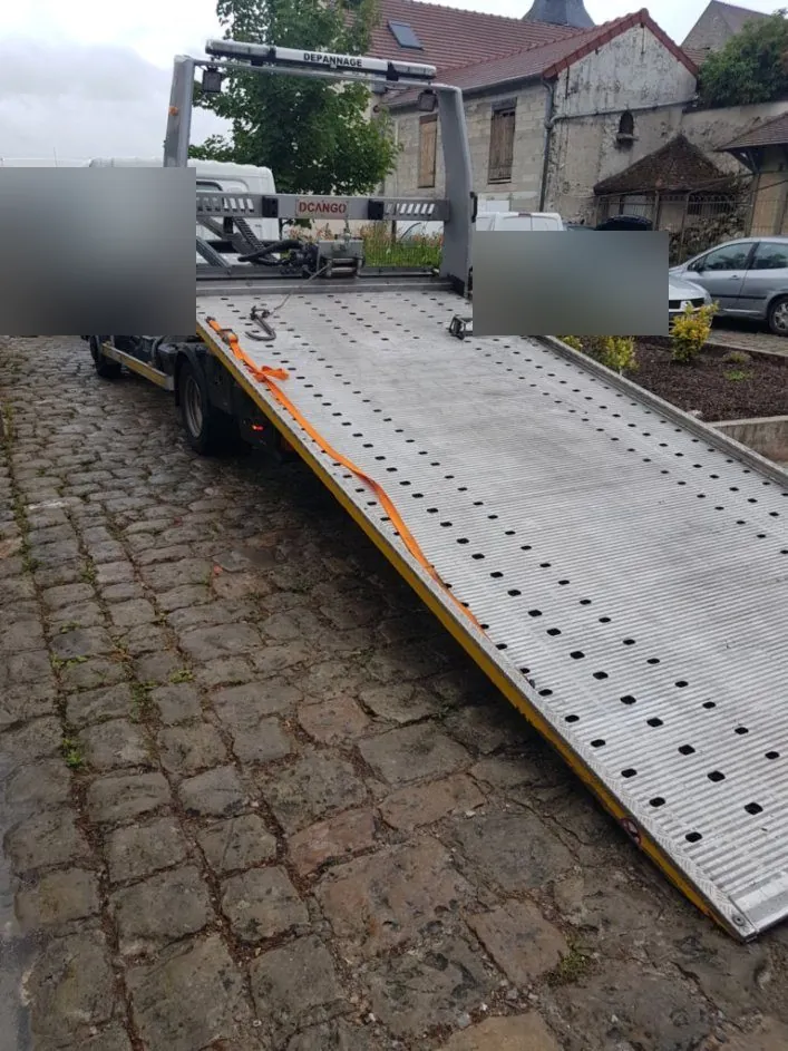 Plateau de dépanneuse baissé sur une cour pavée au Raincy – au Raincy (93340)